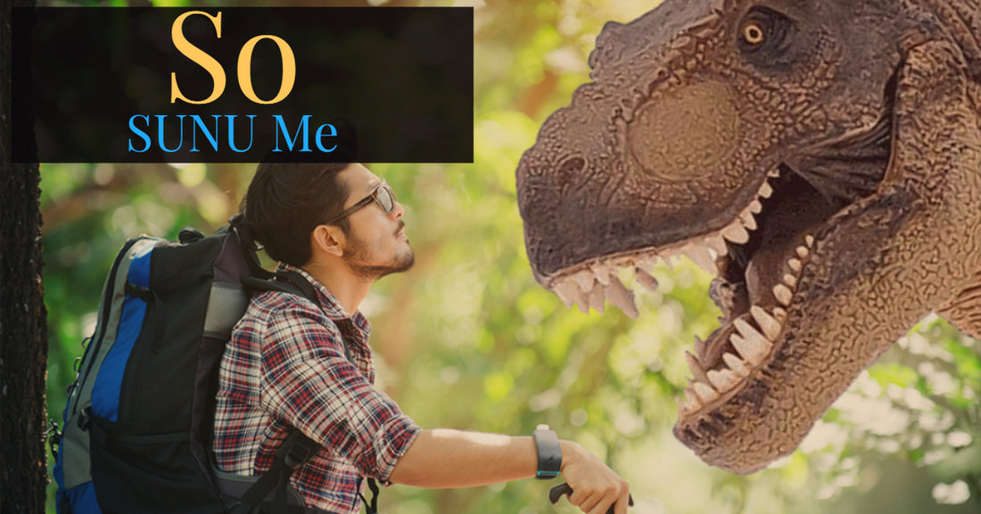 A man wearing a SUNU Band looking at a dinosaur