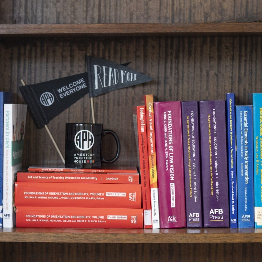 A bookshelf lined with books from APH Press