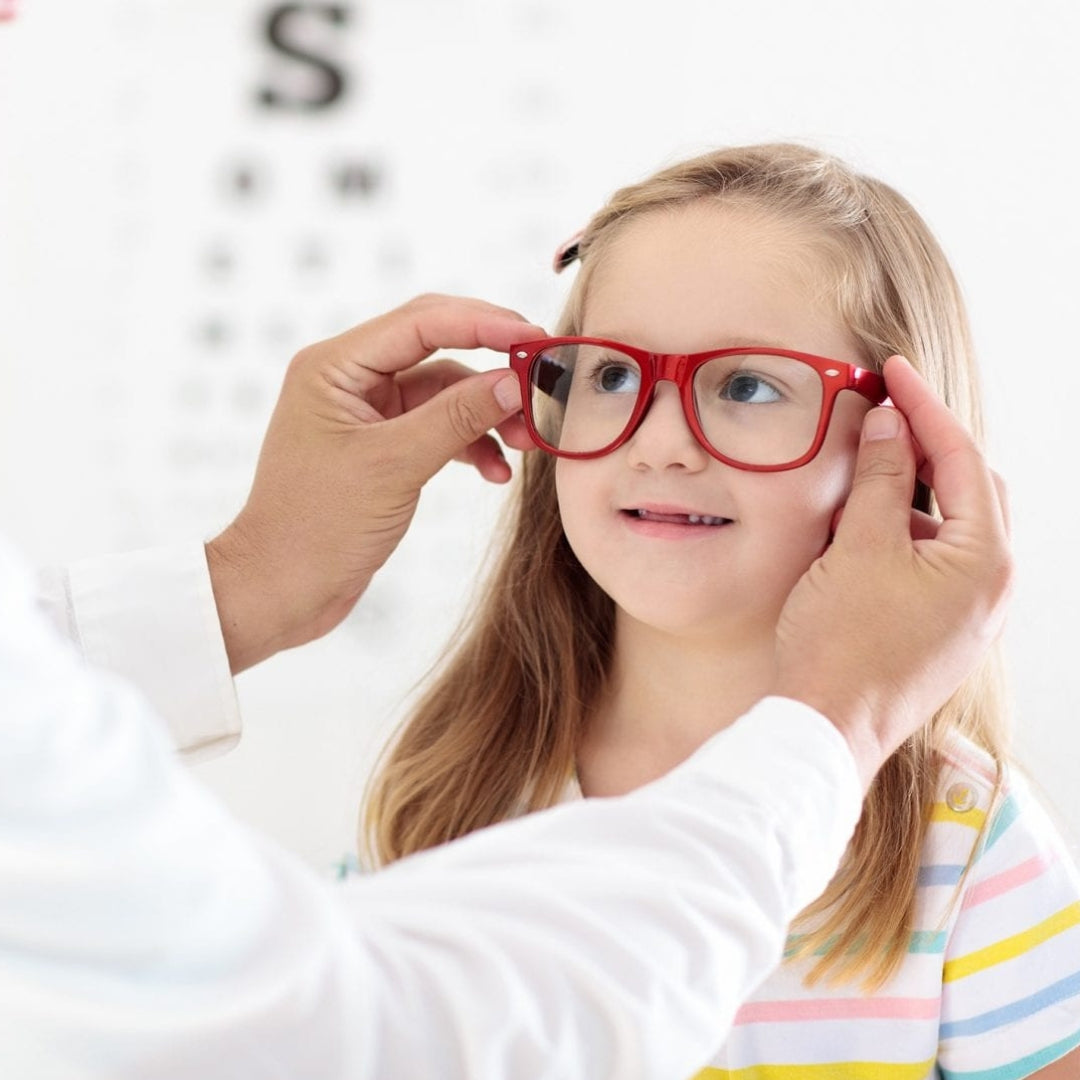Little girl being fitted with a pair of glasses