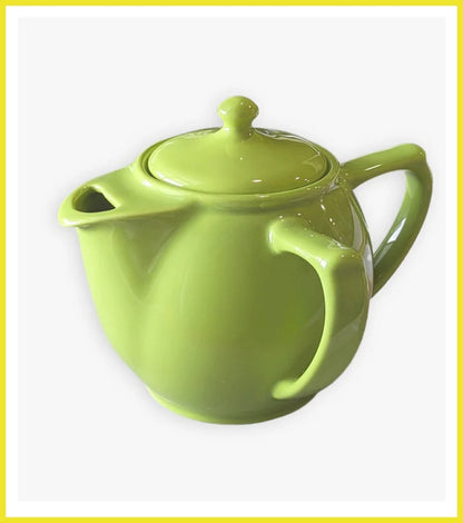 Green teapot on a white background