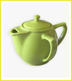 Green teapot on a white background