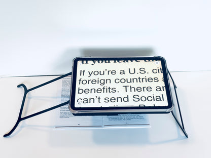 Case resting on a newspaper with text about U.S. citizenship benefits.