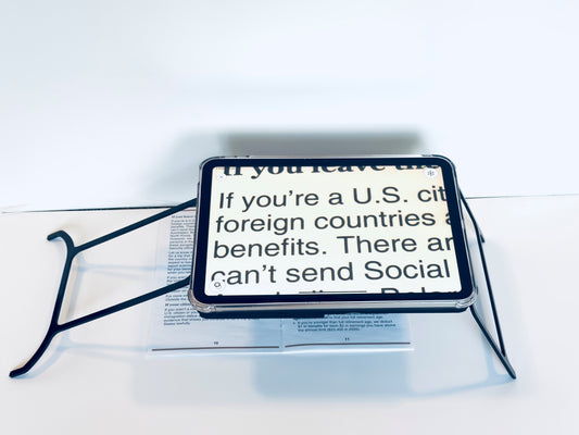 Case resting on a newspaper with text about U.S. citizenship benefits.