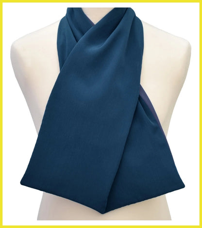 Navy blue scarf draped over a mannequin on a white background