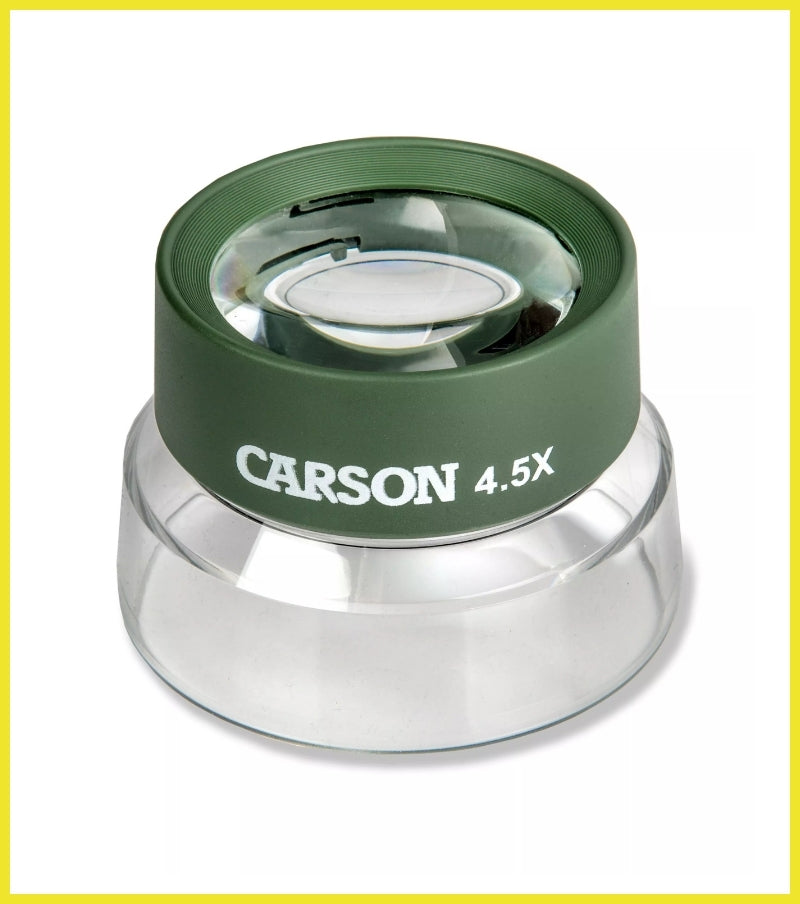 Carson magnifying glass with green rim and clear base on a white background