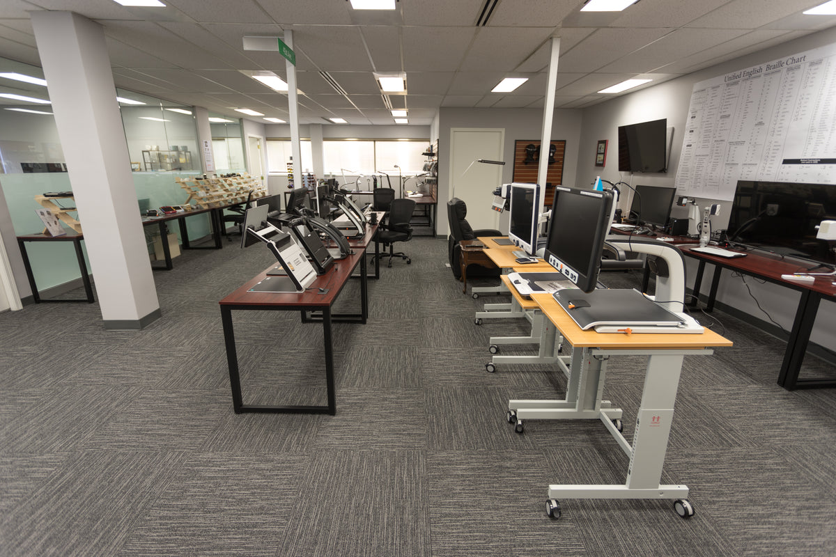 The Canadian Assistive Technology showroom - tables lines with various video magnifiers.