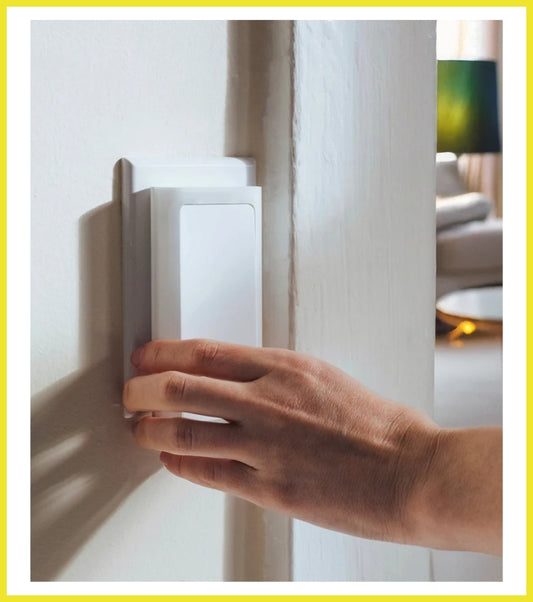 Hand opening a white door with a blurred indoor background
