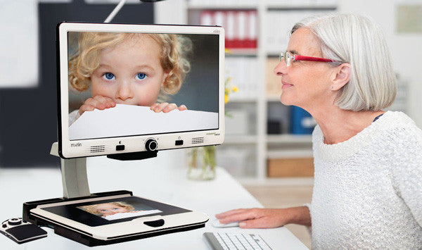 Woman using Merlin Elite Pro to look at picture